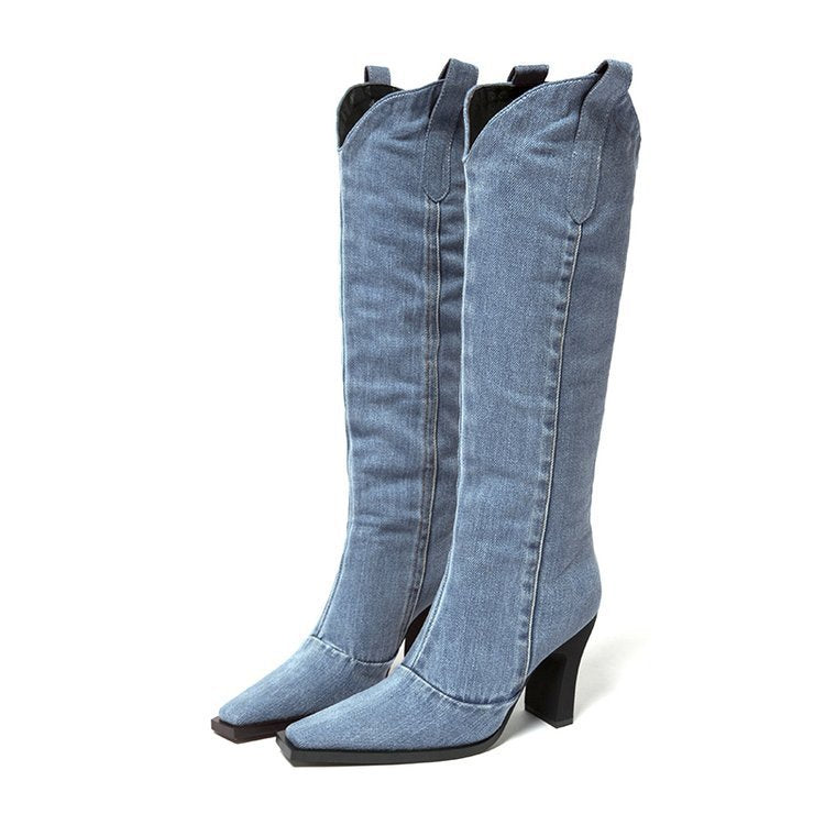 Pair of blue denim knee-high boots on a white background