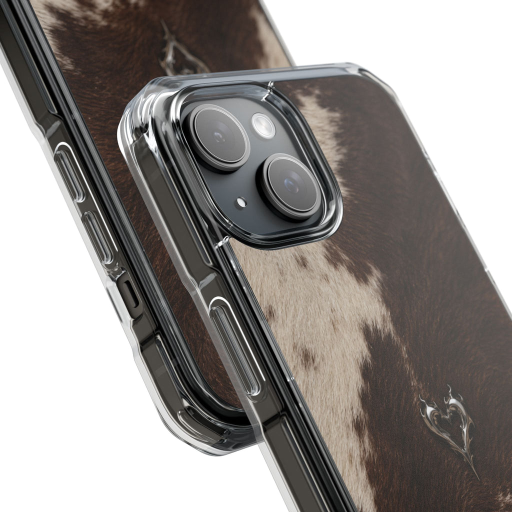 A close-up of a clear protective phone case with a raised camera bezel, shown over a brown and cream cowhide-patterned phone back, on a white background.