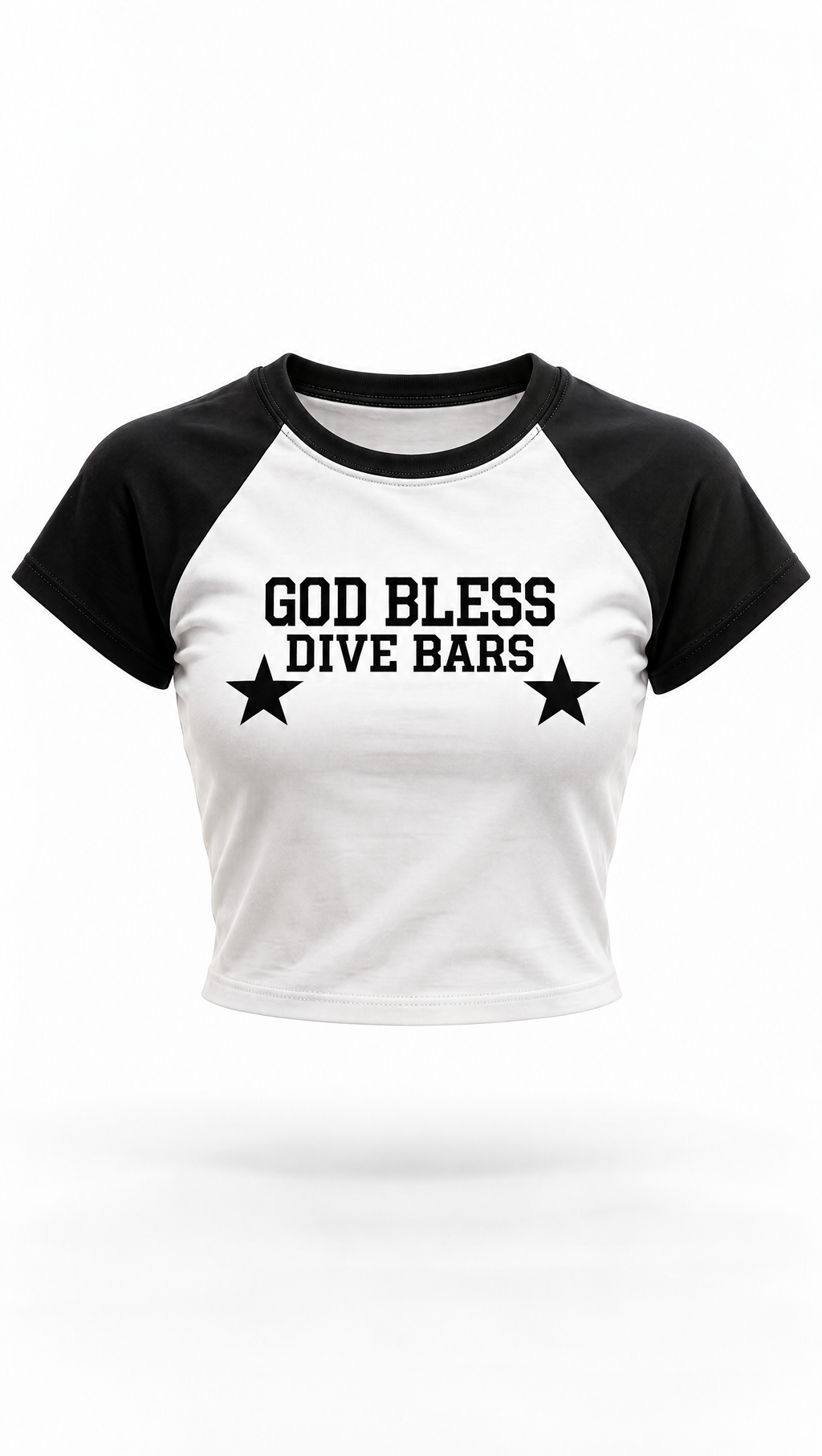 A black and white raglan crop top t-shirt featuring the text 'GOD BLESS DIVE BARS' and two black stars printed on the front, displayed against a plain white background.