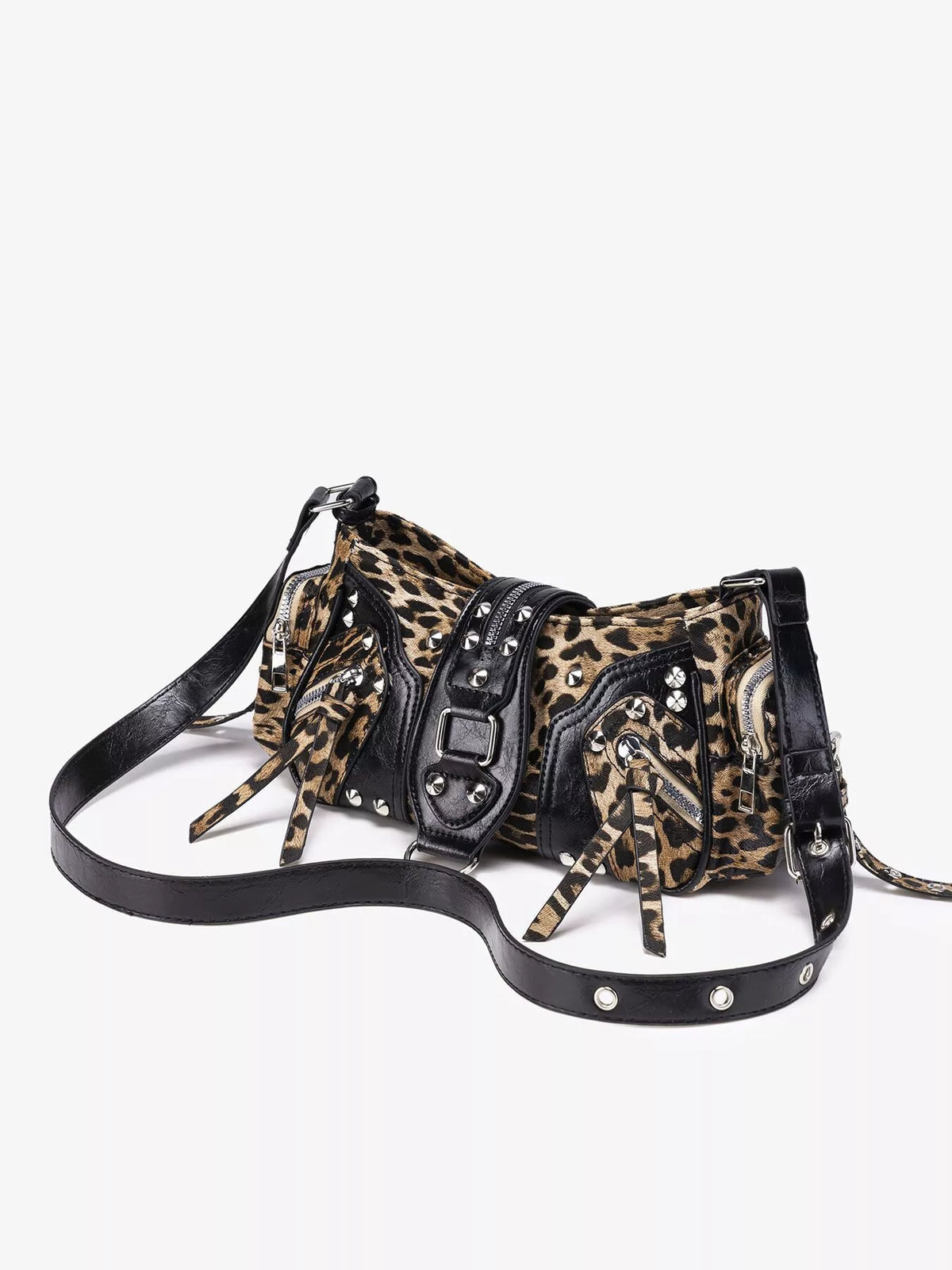 A shoulder bag with a leopard print pattern and black faux-leather straps, buckles, and studs, displayed on a clean white background.