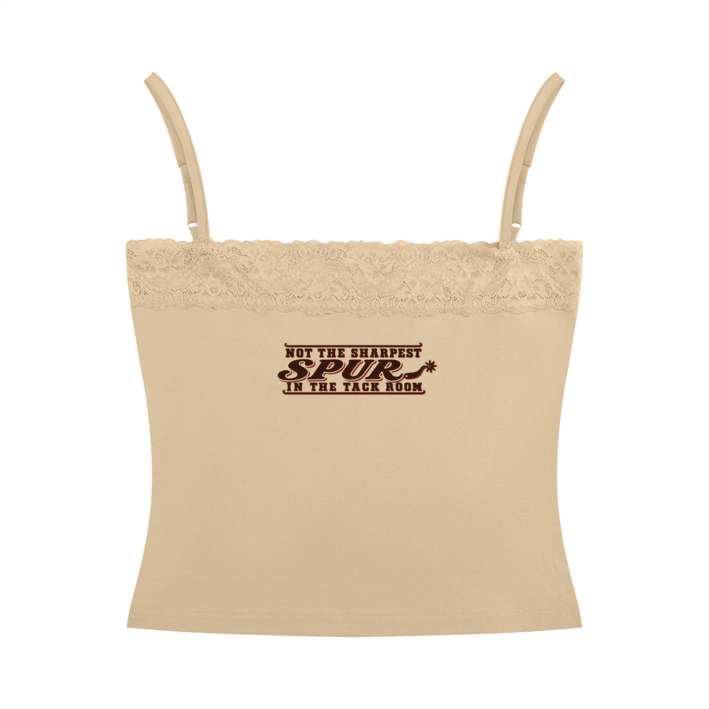 A beige camisole crop top with thin shoulder straps, a lace-trimmed neckline, and a dark brown printed text graphic on the chest reading 'NOT THE SHARPEST SPUR IN THE TACK ROOM'.