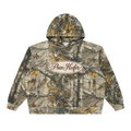 A camouflage pullover hoodie with a realistic woodland tree-bark and leaf pattern in beige, brown, green, and gray tones. It features a central oval chest logo that reads 'Prize Keeper' in black script on a cream background.