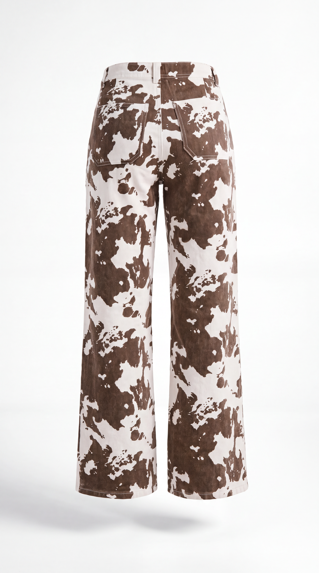 A pair of wide-leg cropped pants featuring a brown and off-white cow print pattern, shown from the back on a white studio background.