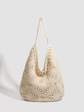 A cream-colored crochet slouchy shoulder bag with an openwork pattern and a single shoulder strap, photographed on a light gray background.