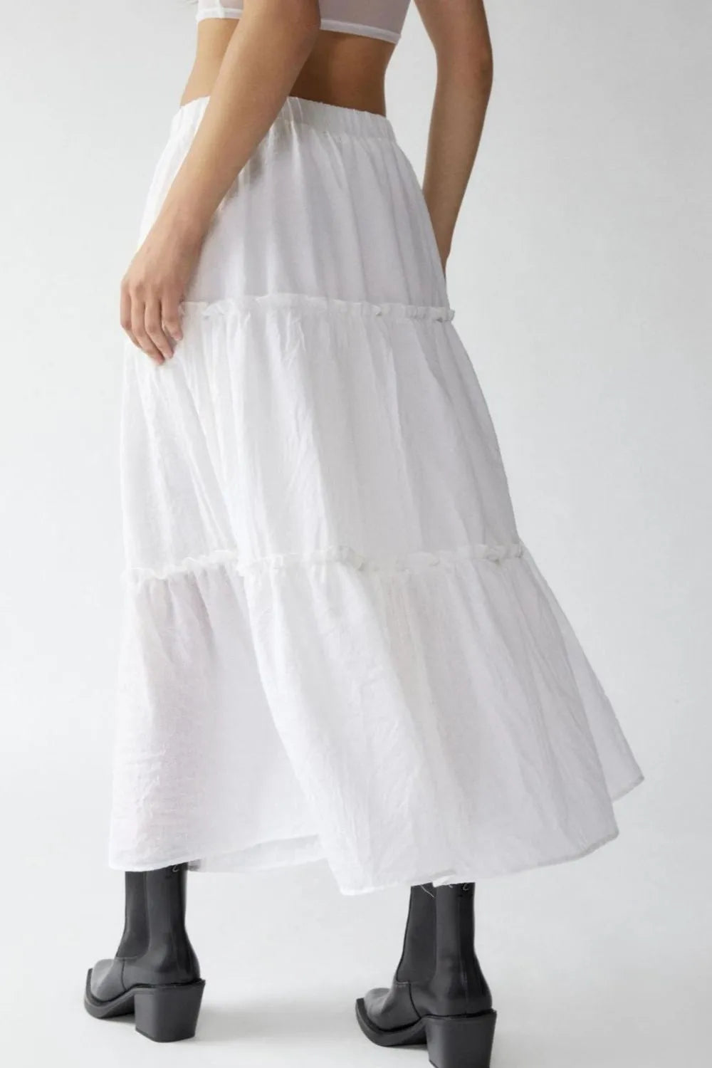 White tiered skirt worn by a person on a white background