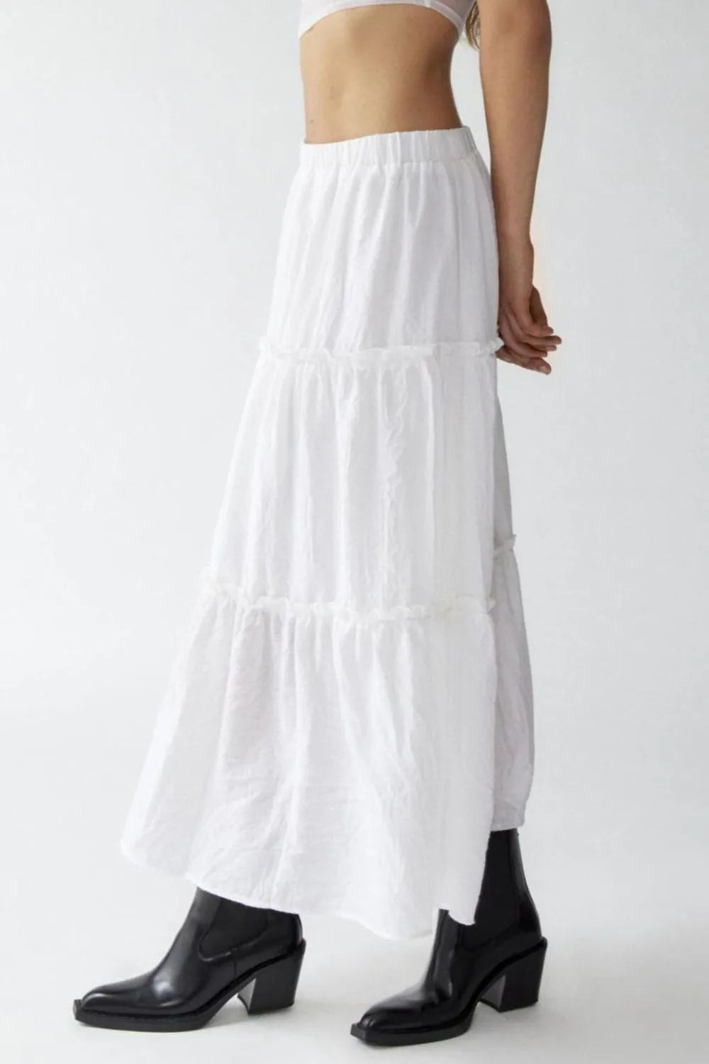 White tiered skirt worn by a person on a white background